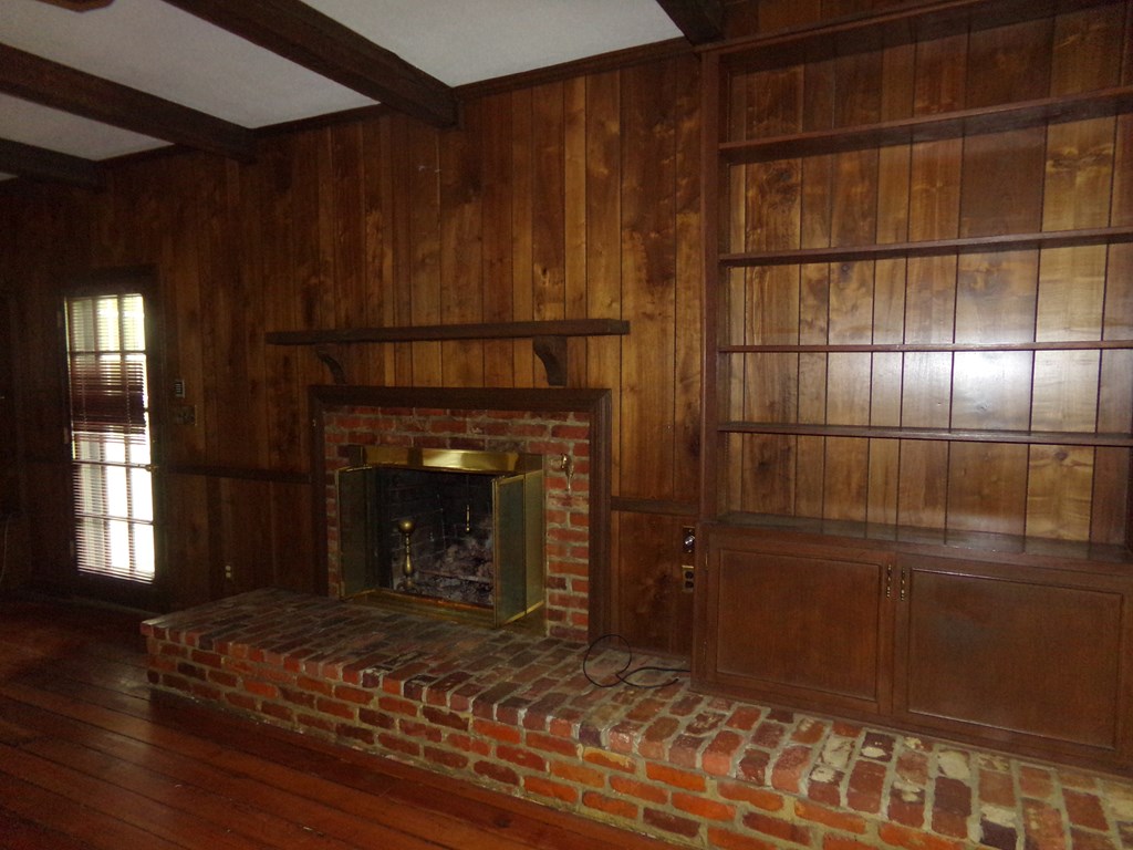View of fireplace and built-ins in den